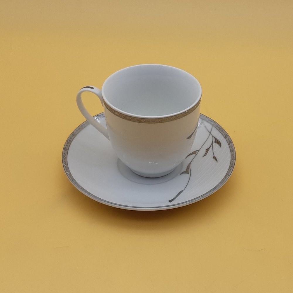 White and Silver Tea Cup and Saucer by RK